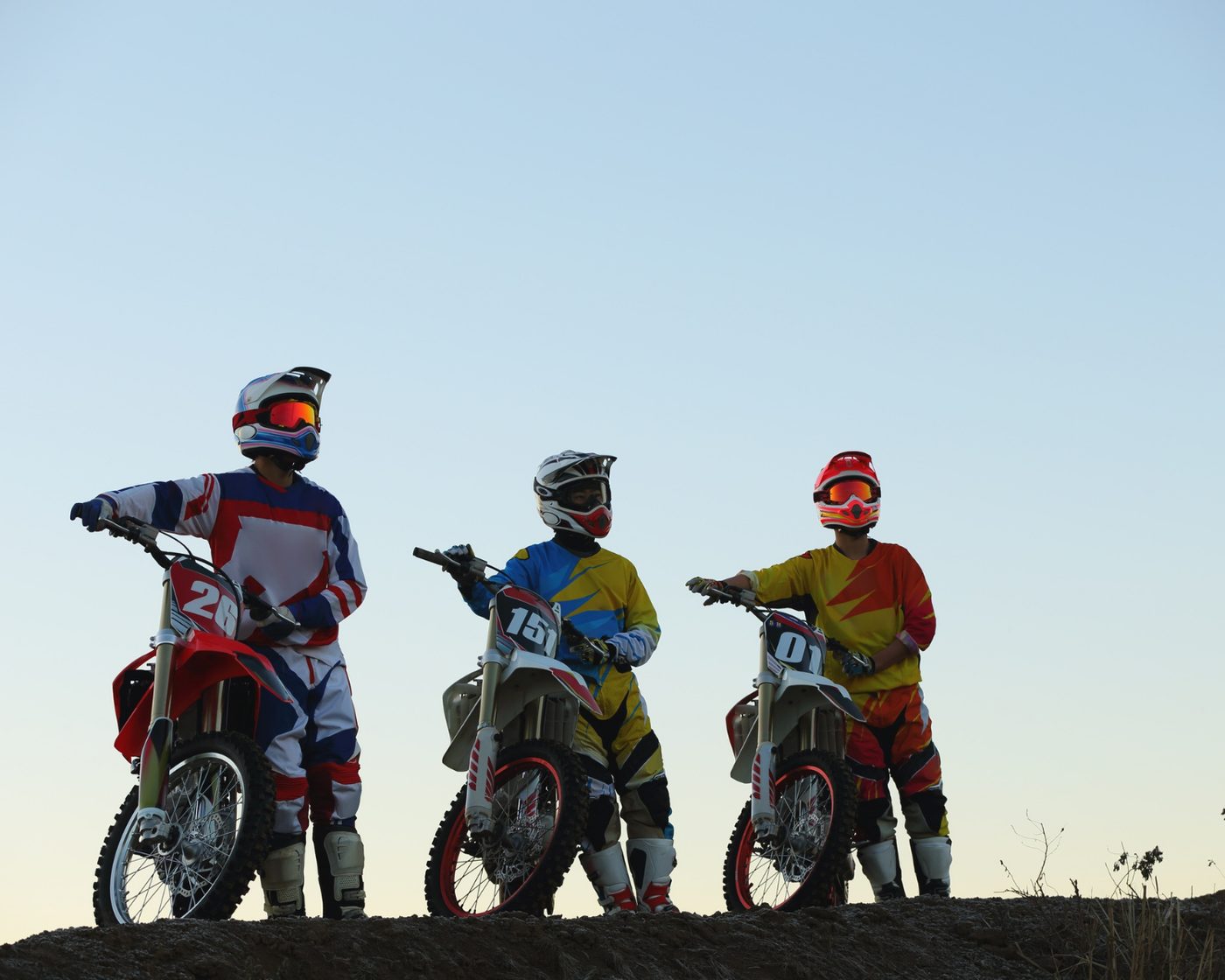 Three riders on berm at golden hour